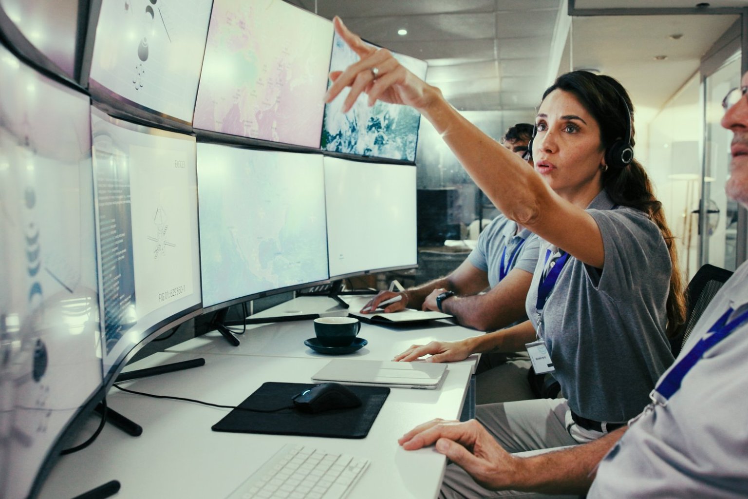 Monitoring staff reviewing data on multiple screens