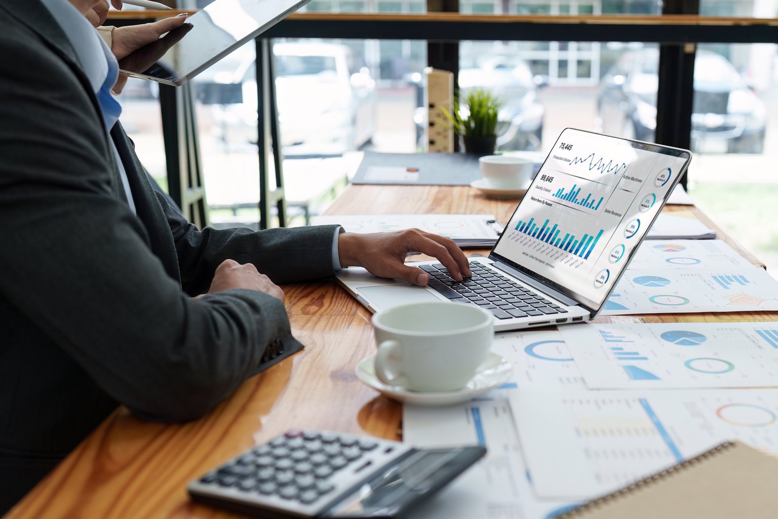 Staff reviewing revenue dashboards and financial reports at a desk